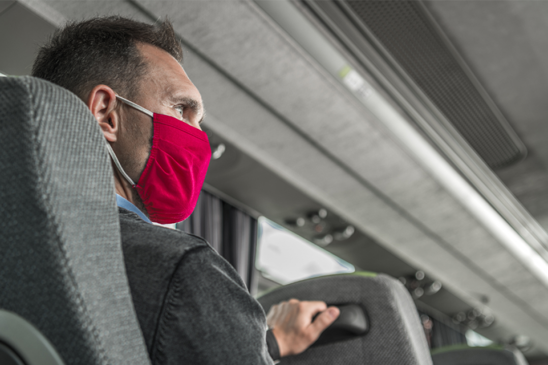 Man on bus wearing mask