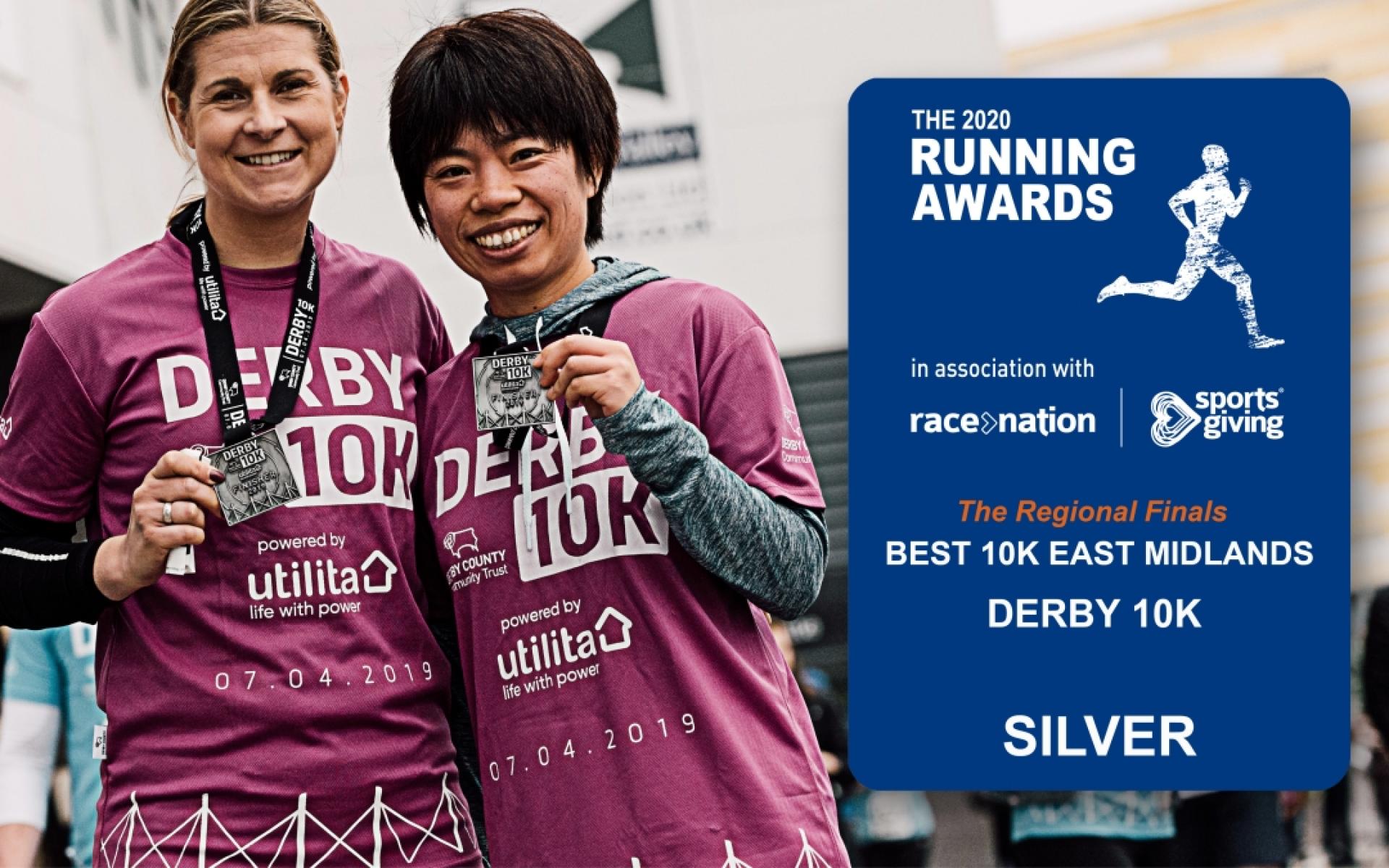 Two female runners holding up Derby 10K medals.  