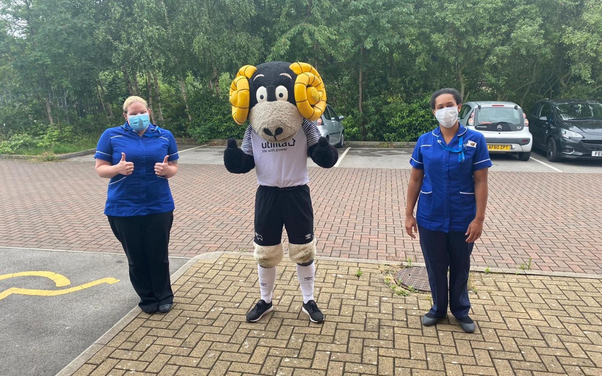 Rammie standing with two NHS nurses.