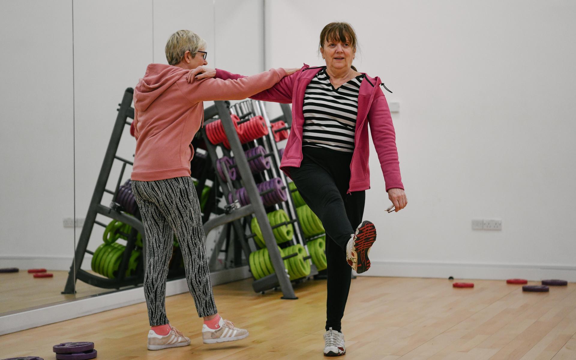 Two women exercising.