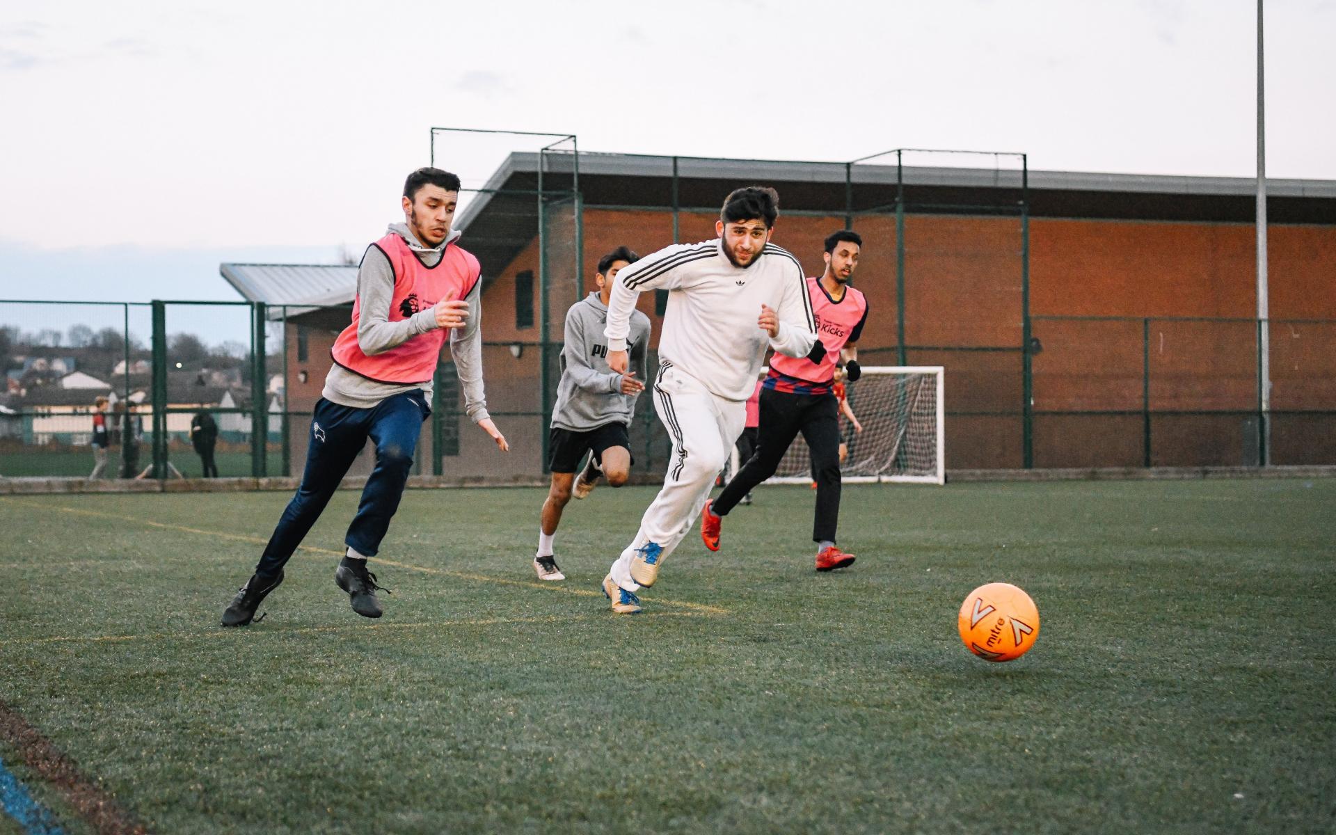 Young males playing football.
