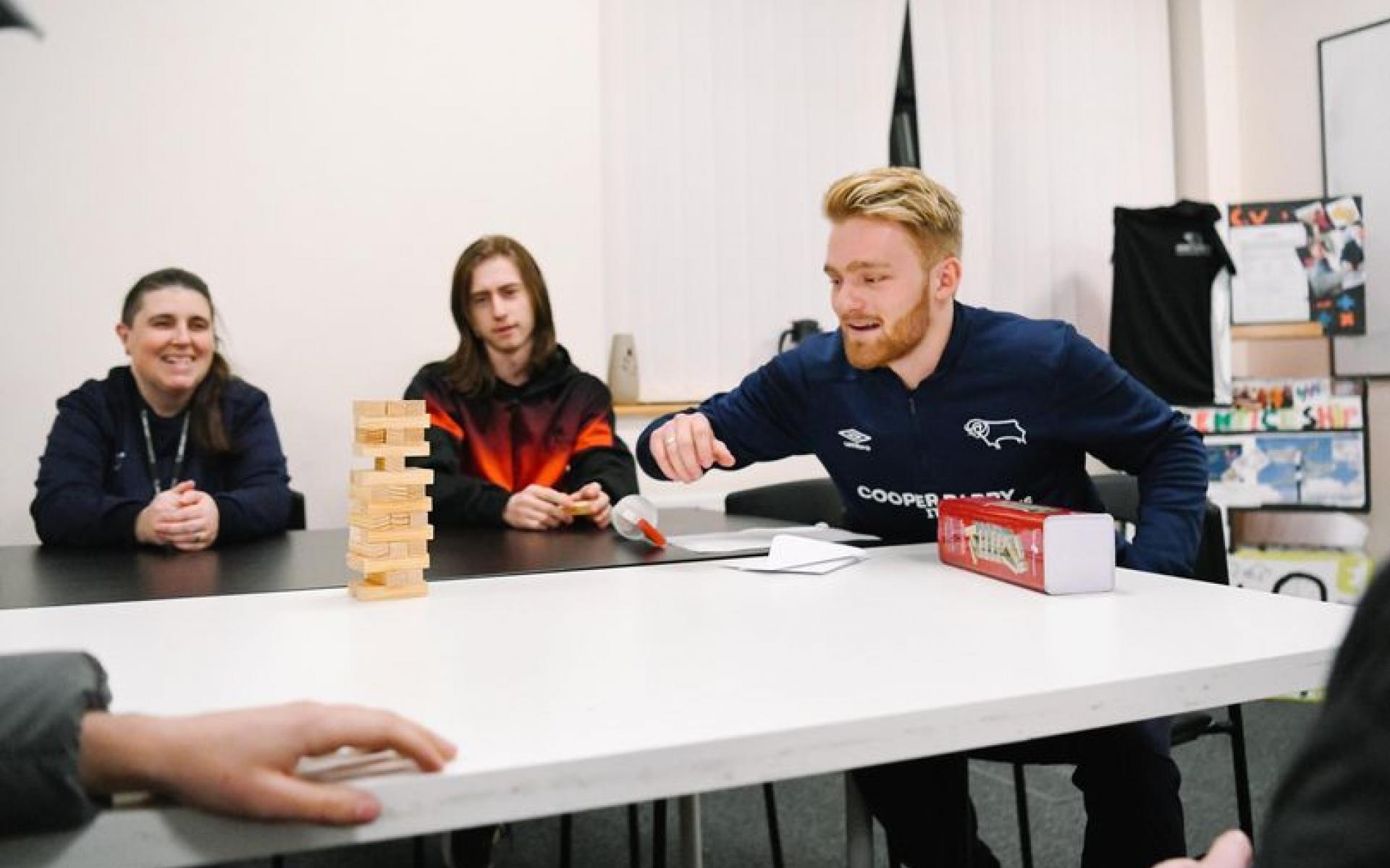 Group of people smiling sitting at a table