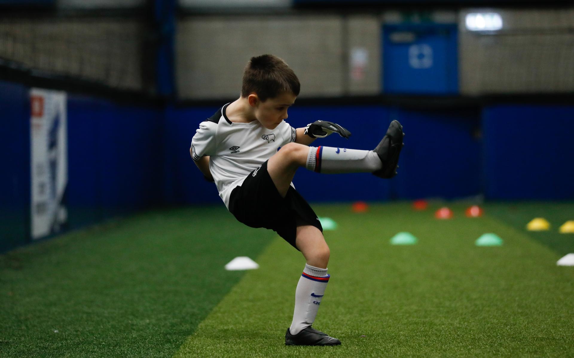 Child kicking ball