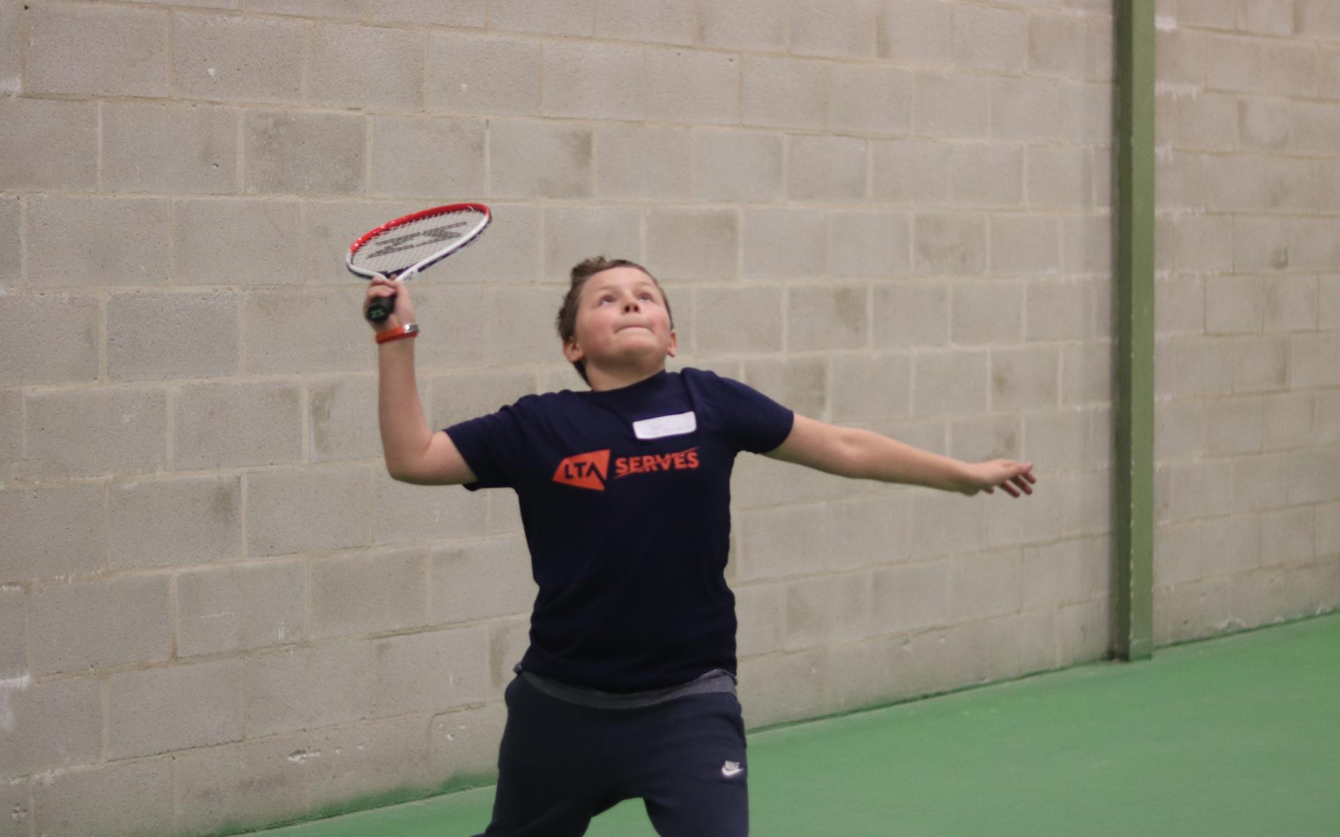 Child playing tennis