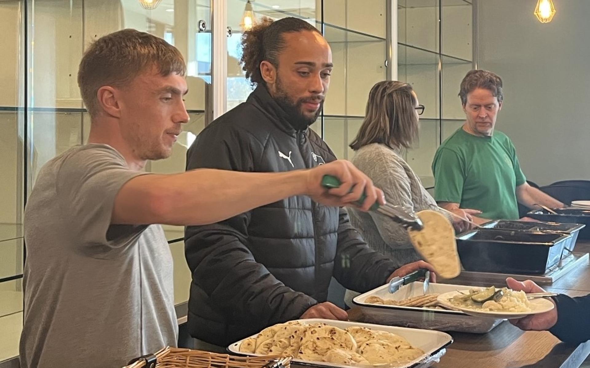 Ben and Marcus serving food at community meals