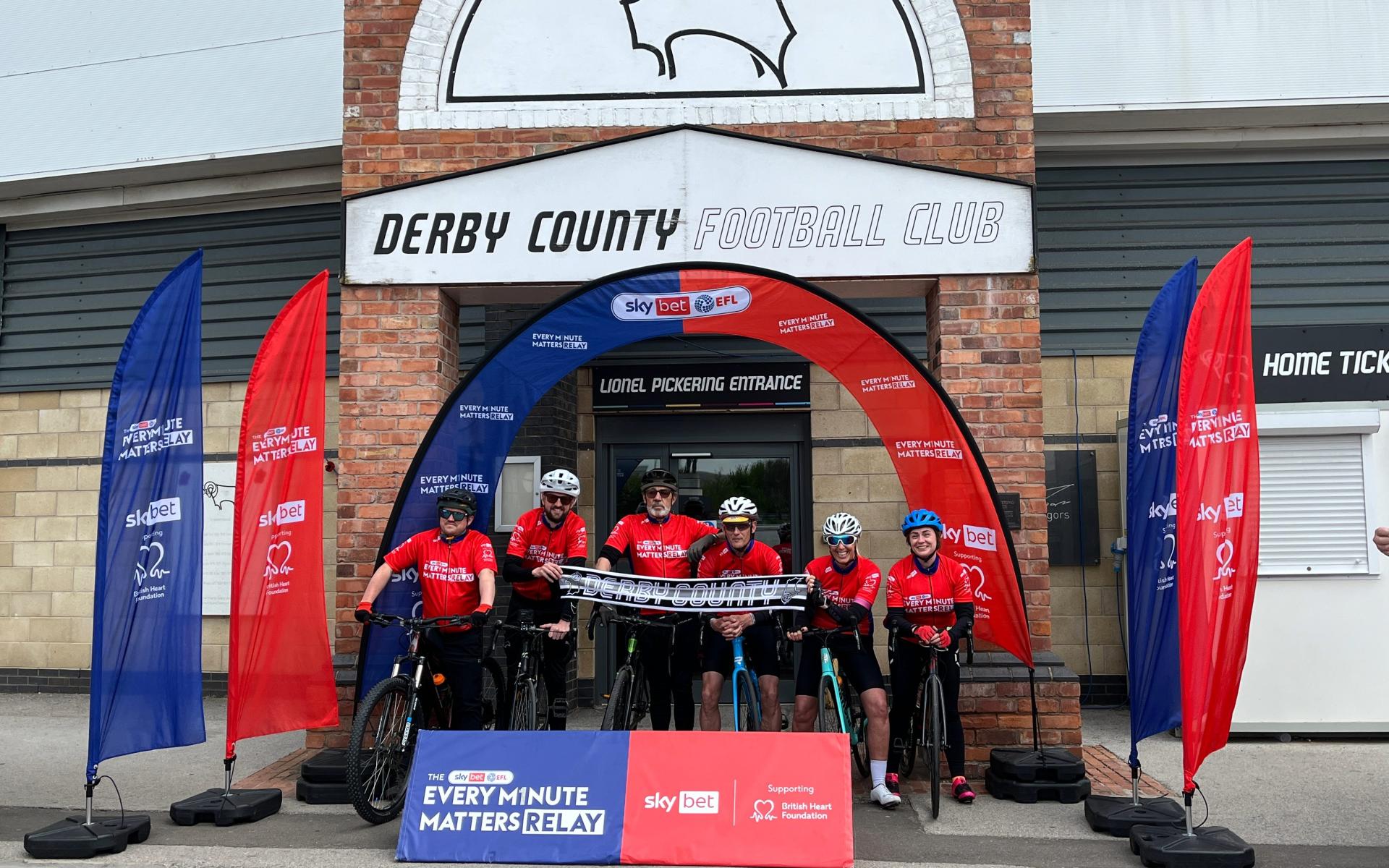 The cycle riders outside the Lionel Pickering entrance to Pride Park stadium