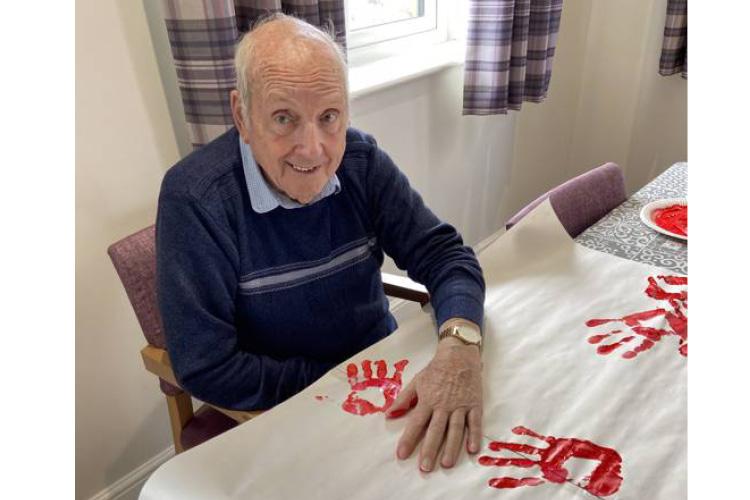 Male service user painting