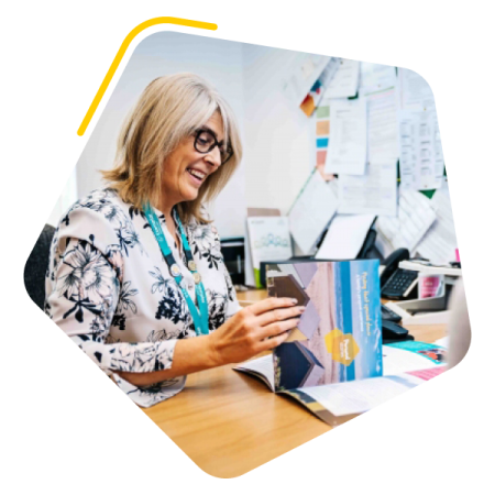 Manager sat at desk with care worker
