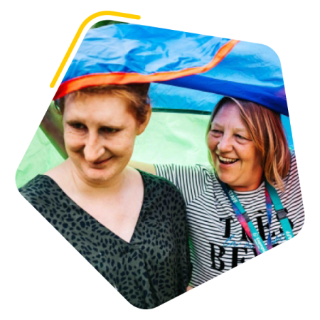 Female care worker with female service user under a kite