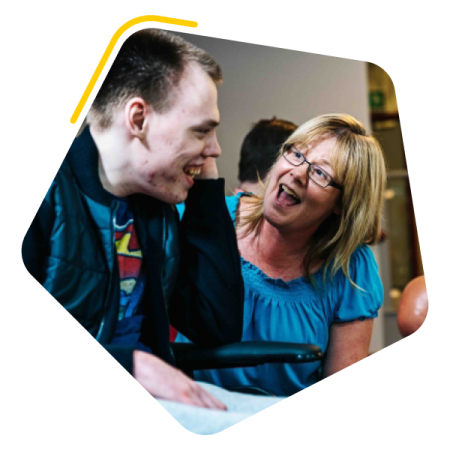 Male service user bowling with female care worker
