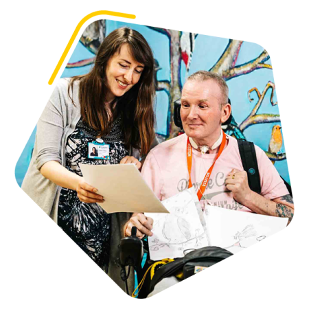Male service user reading a document with Manager