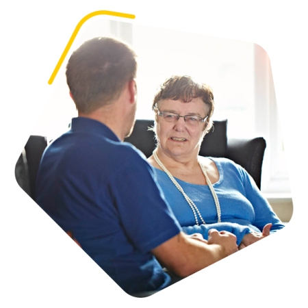 Female service user sat chatting to a care worker
