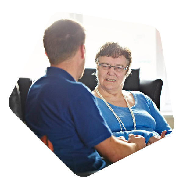 Female service user sat talking to a male carer