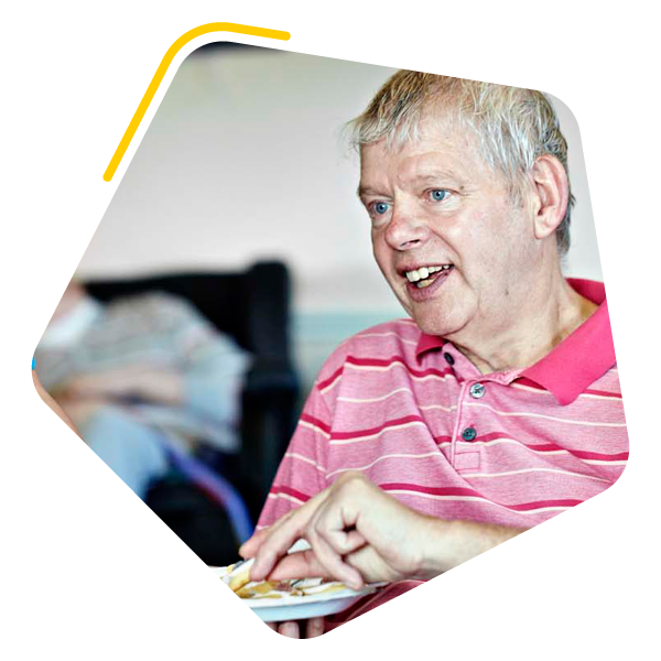 Male service user eating a biscuit
