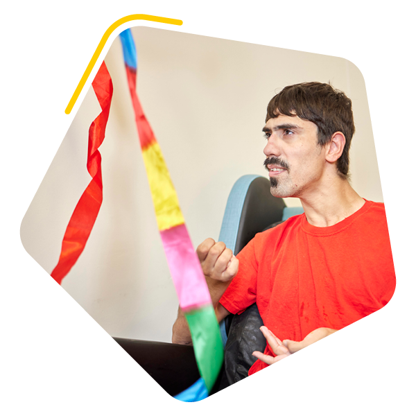 Person in care home playing with a ribbon