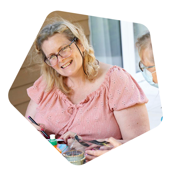Female care worker sat with a female resident