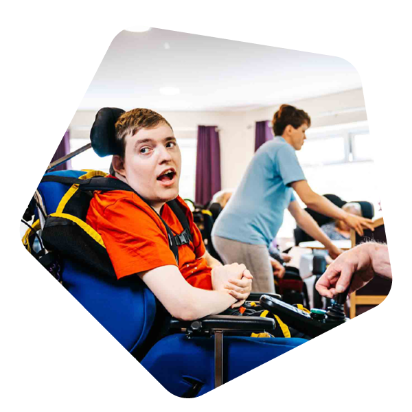 Male sat in an electric wheelchair in care home