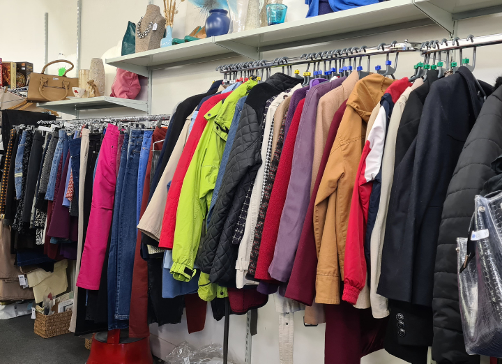 A row of clothing in a charity shop