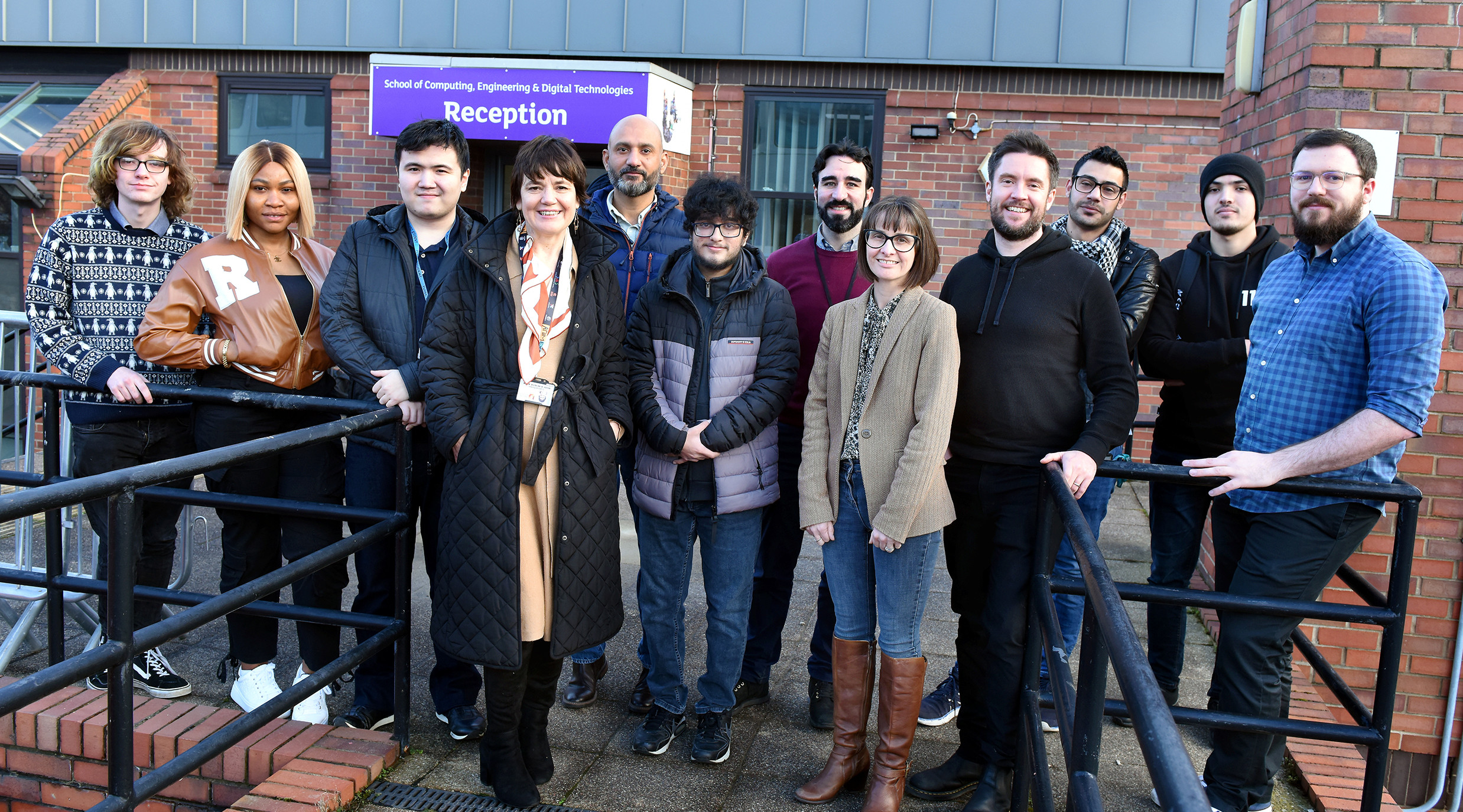 Students and representatives from Waterstons standing outside a building