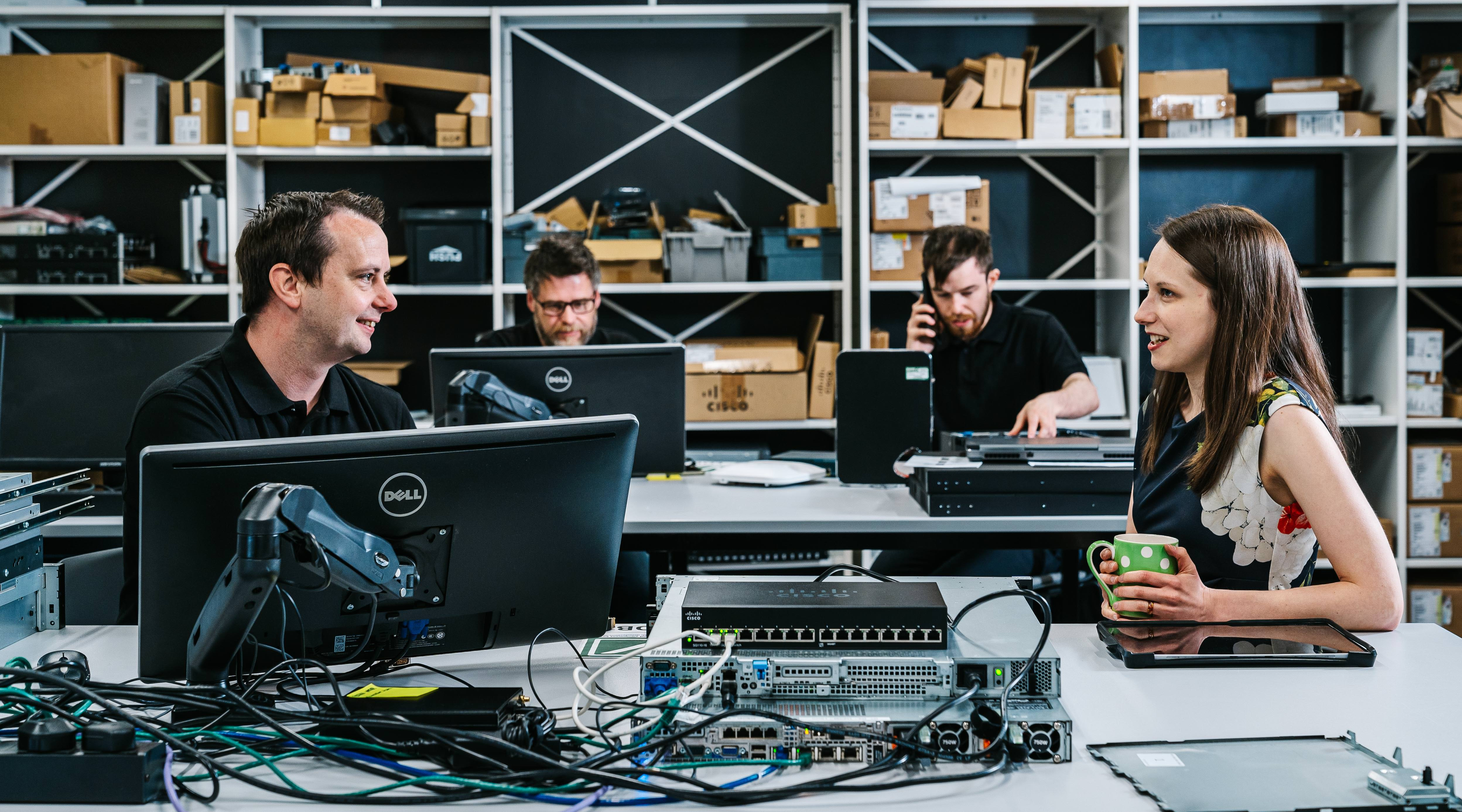 A group of Waterstons employees working together 