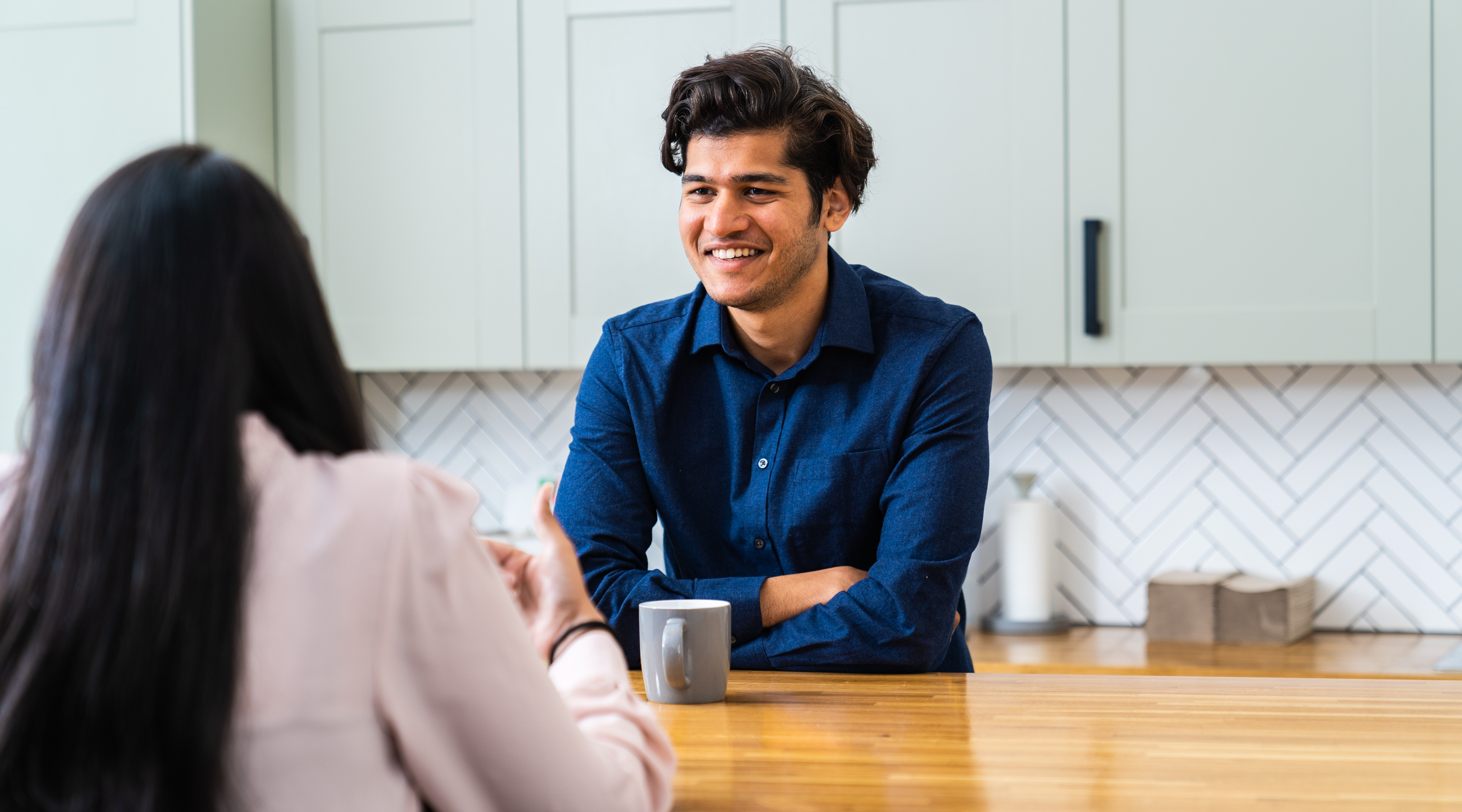 Two Waterstons employees talking over a coffee