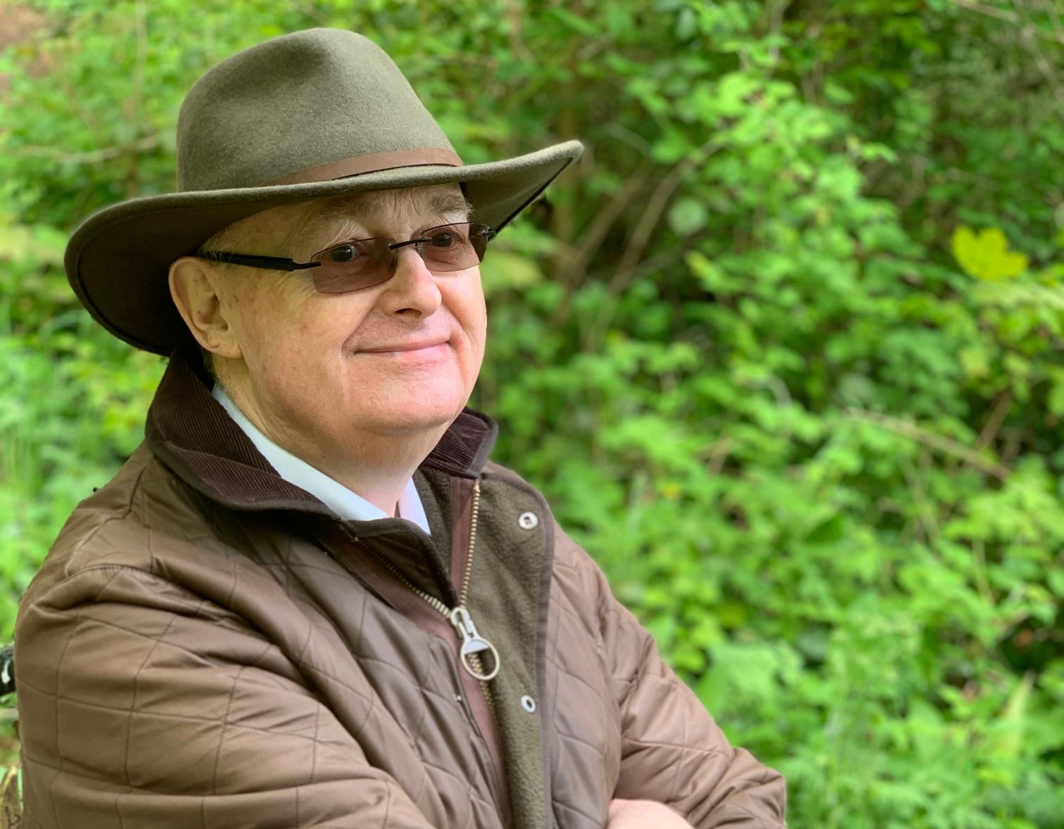 A man sitting on a bench smiling