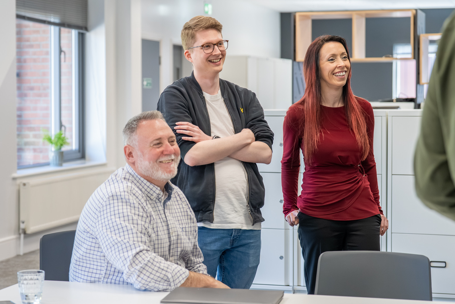 three colleagues in a stand up meeting