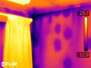 A thermal image of someone's bedroom showing where heat is escaping.
