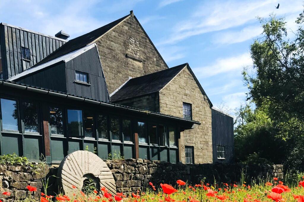 Caudwell Mill Trust cottage behind poppy fields 